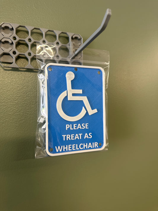 “Please treat as wheelchair” sign